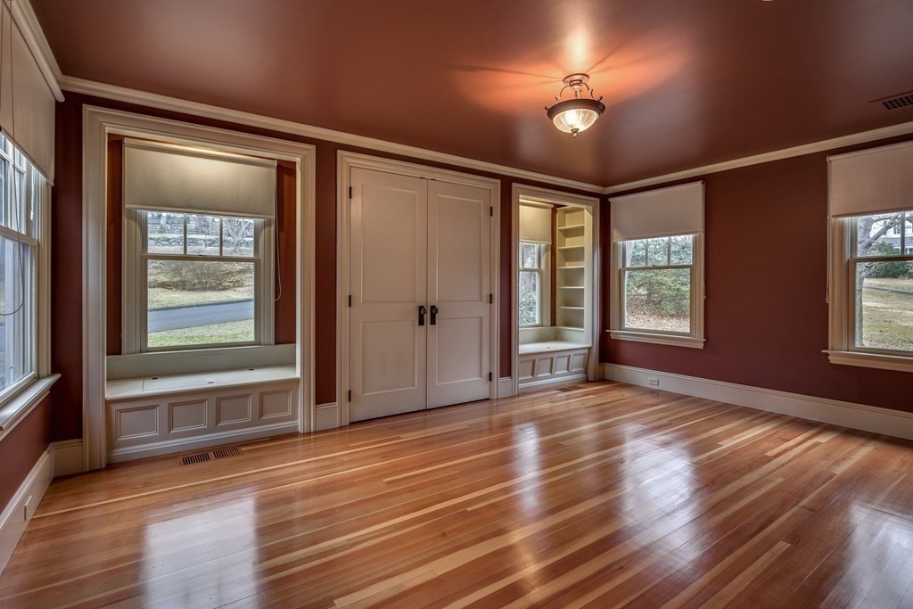 7 Percy Road Lexington, MA 02421 - Photo 21 of 29 an empty room with wooden floor and windows