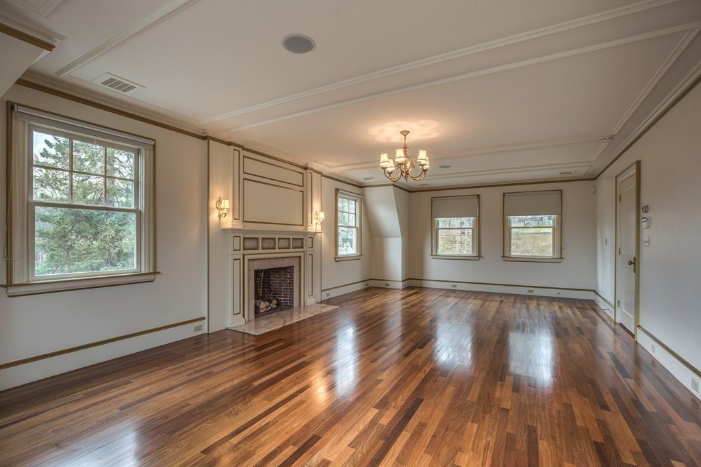 7 Percy Road Lexington, MA 02421 - Photo 25 of 29 a view of an empty room with wooden floor fireplace and a window