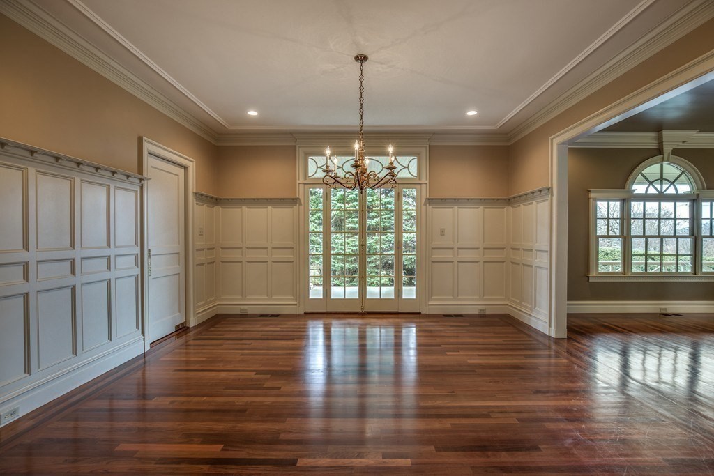 7 Percy Road Lexington, MA 02421 - Photo 9 of 29 a view of an empty room with wooden floor and a window