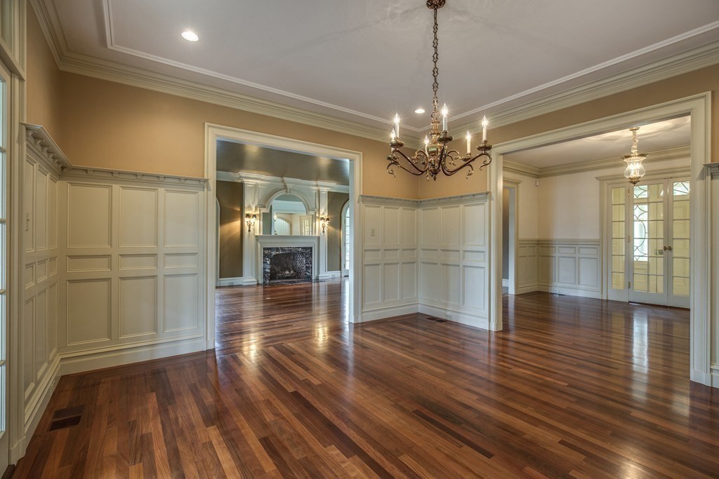7 Percy Road Lexington, MA 02421 - Photo 10 of 29 a view of a hallway with wooden floor and a kitchen