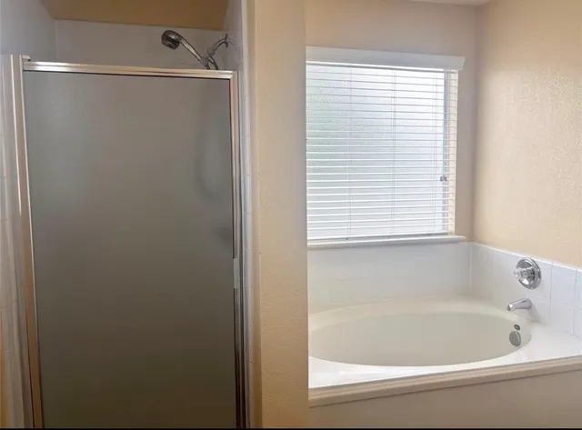a white bath tub sitting next to a window