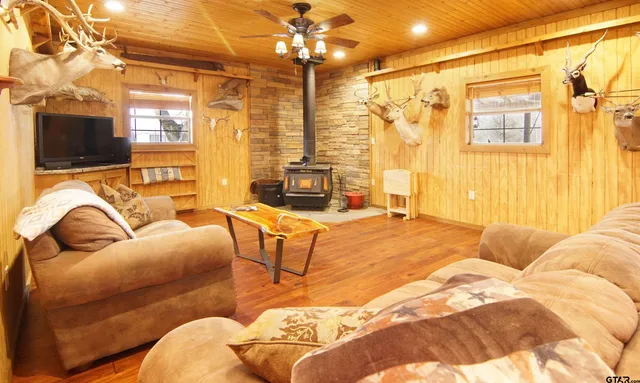 a room with table chairs and mirrors