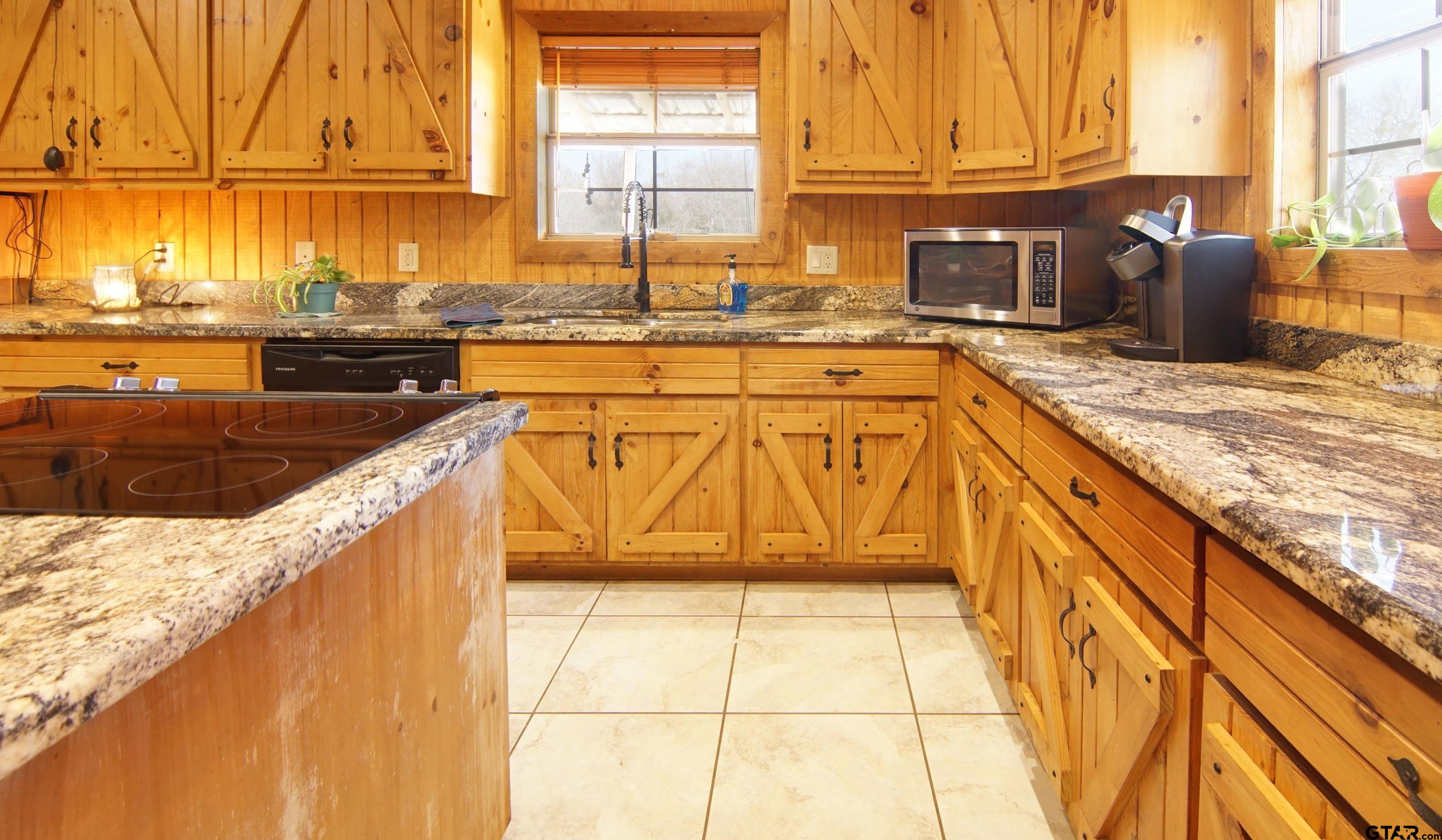 342 Rscr 3345 Emory, TX 75440 - Photo 19 of 31 a kitchen with stainless steel appliances granite countertop a sink and cabinets