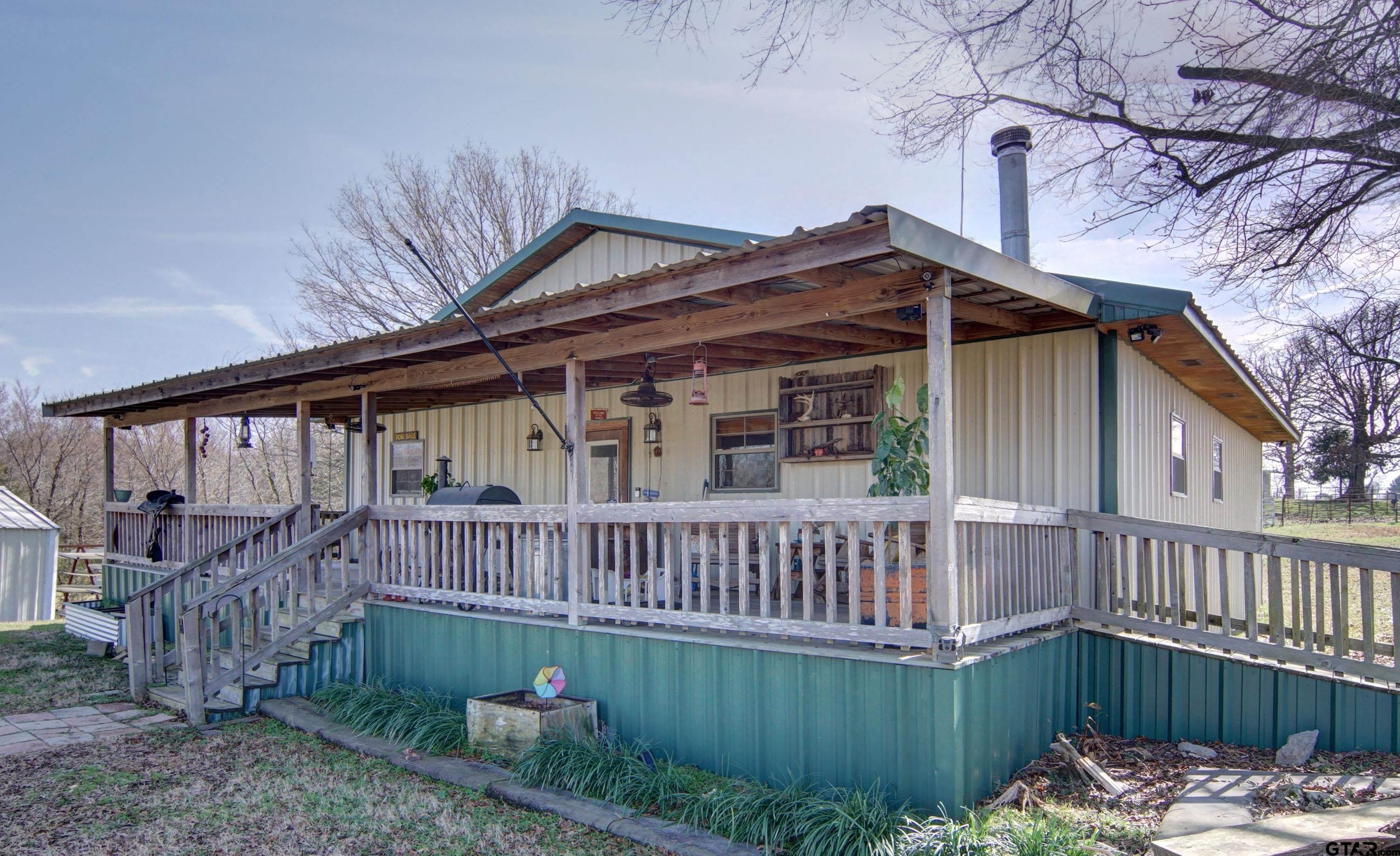 342 Rscr 3345 Emory, TX 75440 - Photo 3 of 31 a view of a house with a wooden deck and a yard