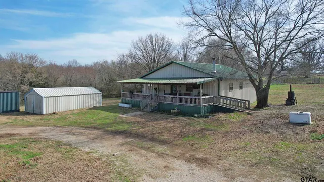 a view of a patio with wooden floor of a house
