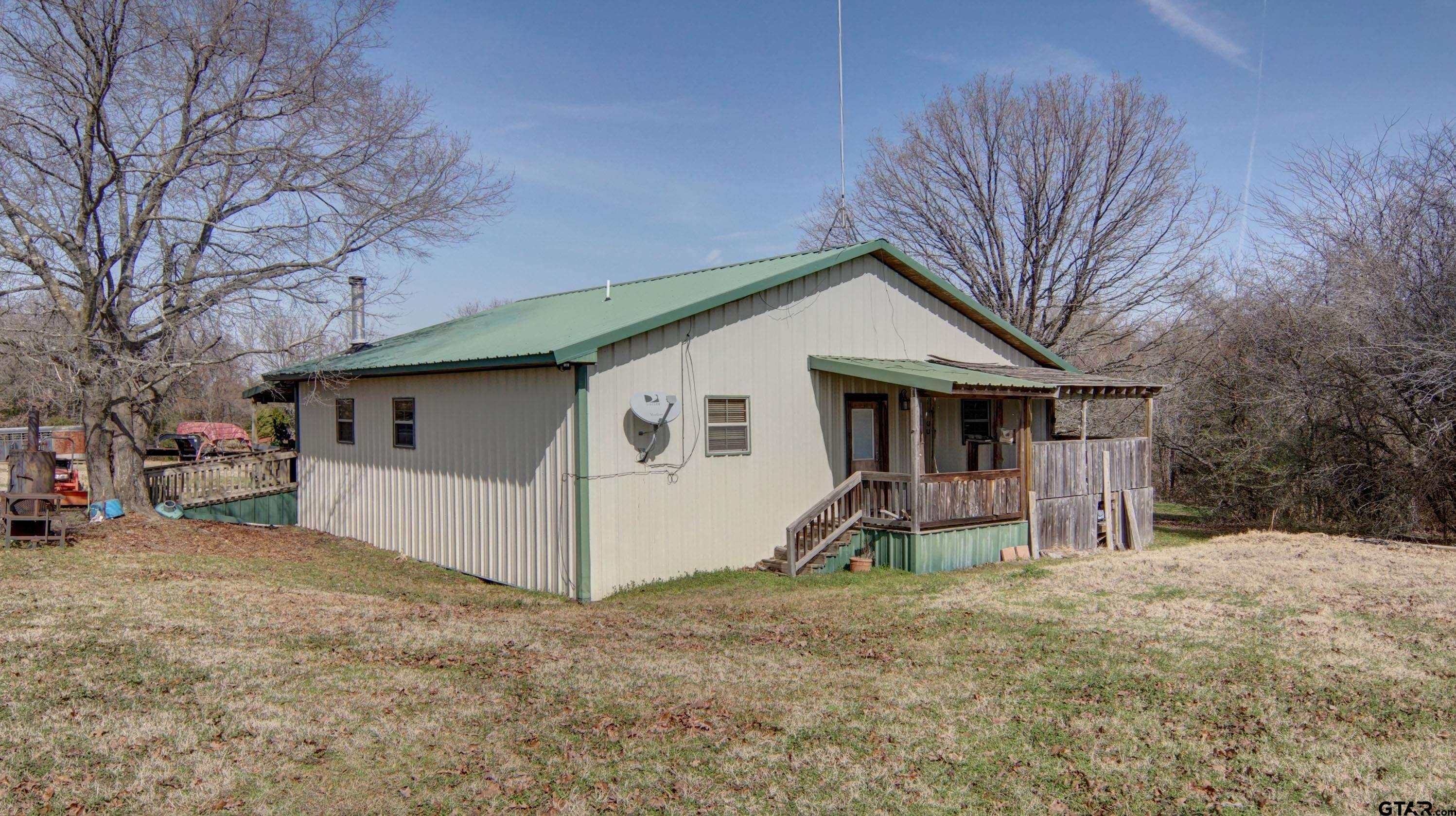 342 Rscr 3345 Emory, TX 75440 - Photo 8 of 31 a view of a house with a yard and garage