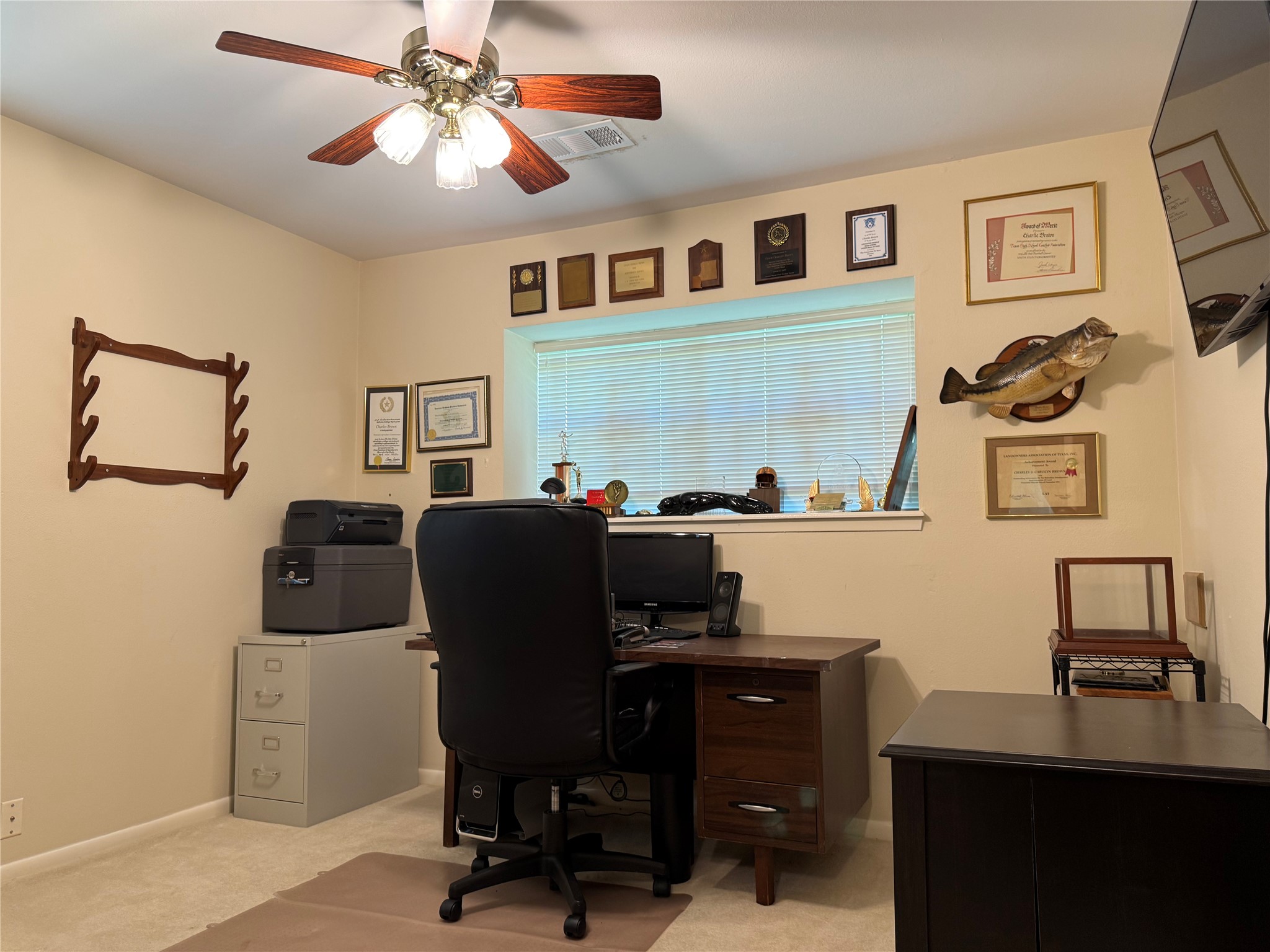 203 East Thornton Road Houston, TX 77022 - Photo 11 of 18 Second bedroom down used as a cozy home office with neutral walls, a ceiling fan, and a window with a view of the front yard