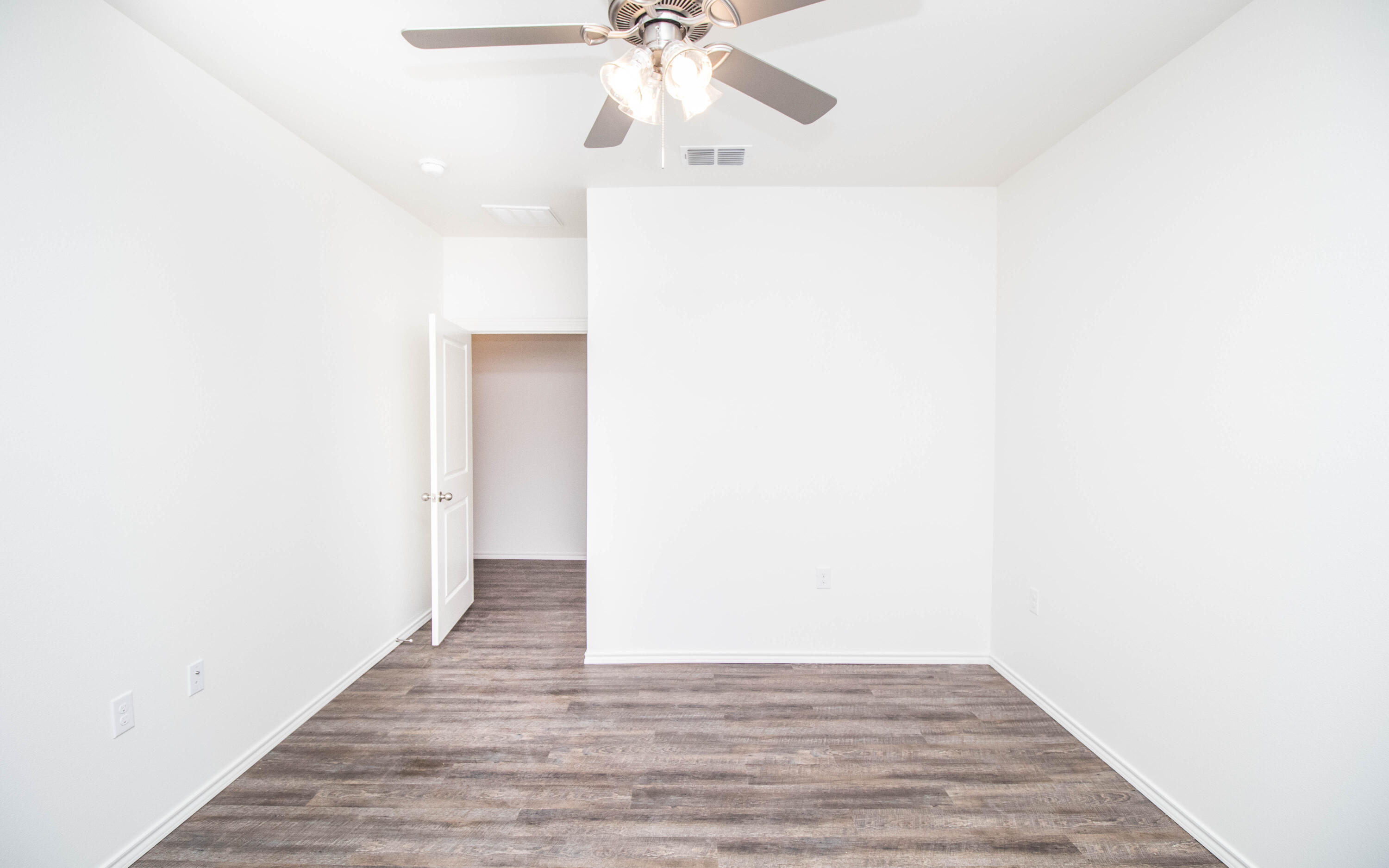 6914 21st Street Lubbock, TX 79407 - Photo 20 of 36 a view of an empty room with wooden floor