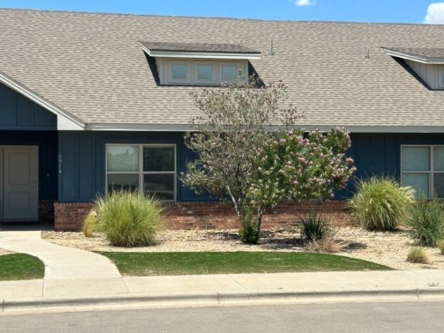 6914 21st Street Lubbock, TX 79407 - Photo 3 of 36 a front view of a house with garden