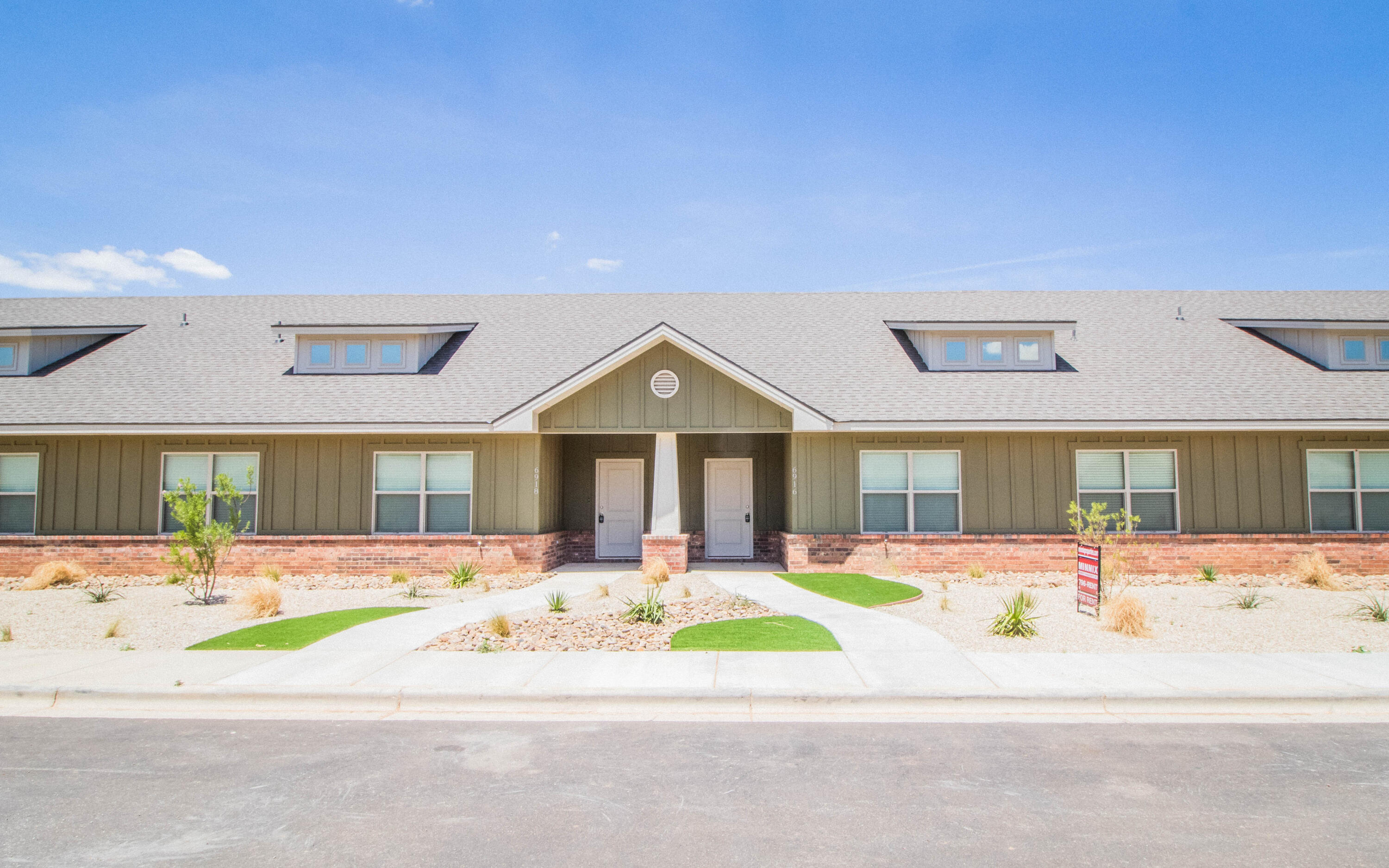 6914 21st Street Lubbock, TX 79407 - Photo 36 of 36 a front view of a house with a yard and potted plants