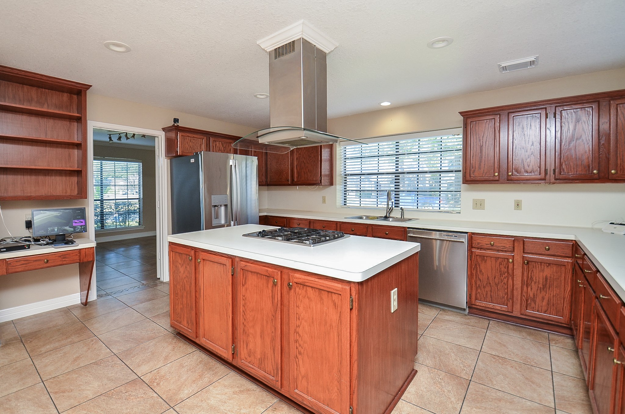 8803 Tweedbrook Drive Spring, TX 77379 - Photo 14 of 36 Take a look at this gorgeous brown cabinetry that offers ample storage space for all of your culinary needs.