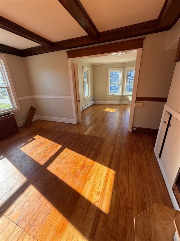 57 Colfax Street, Unit 57 Fall River, MA 02720 - Photo 4 of 7 a view of an empty room with wooden floor and a window