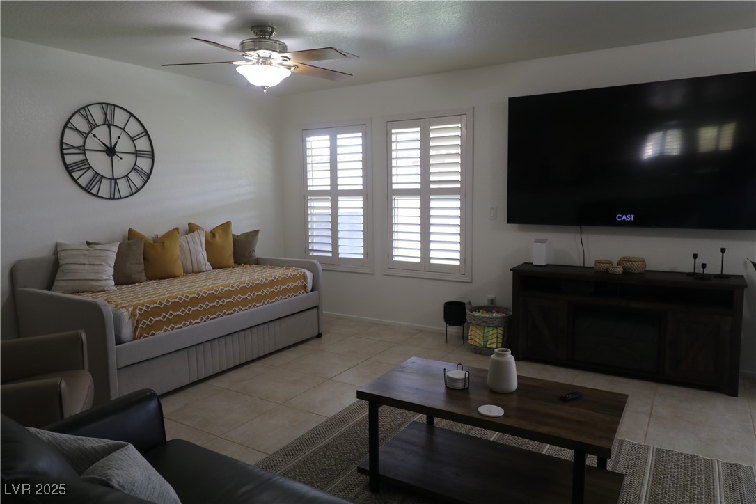 Undisclosed Address Las Vegas, NV 89118 - Photo 4 of 19 Living area featuring baseboards, a ceiling fan, a