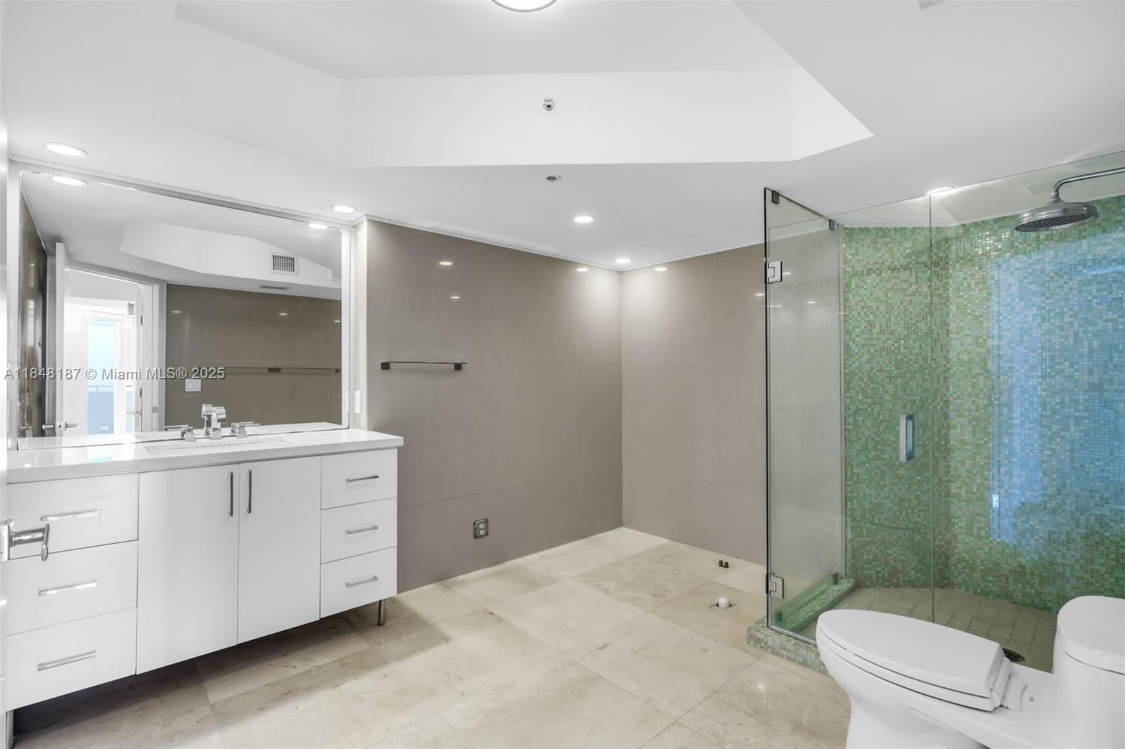 6301 Collins Avenue, Unit 1903 Miami Beach, FL 33141 - Photo 19 of 45 a bathroom with a double vanity sink toilet and shower