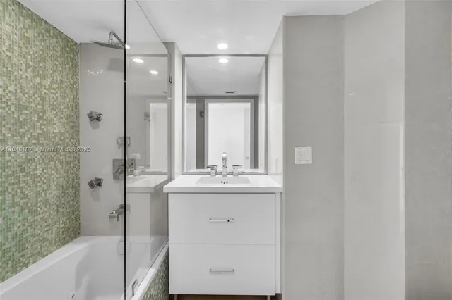 a bathroom with a sink a mirror and a vanity