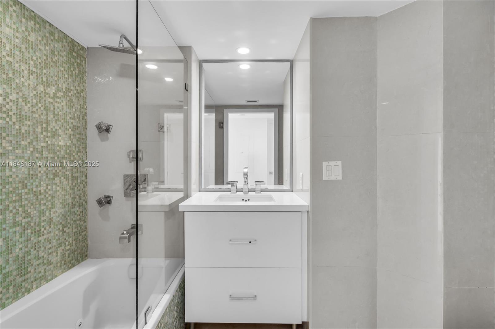 6301 Collins Avenue, Unit 1903 Miami Beach, FL 33141 - Photo 25 of 45 a bathroom with a granite countertop sink a toilet and shower