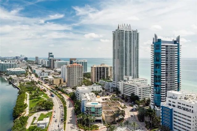 a multi story building with a tree in front of it