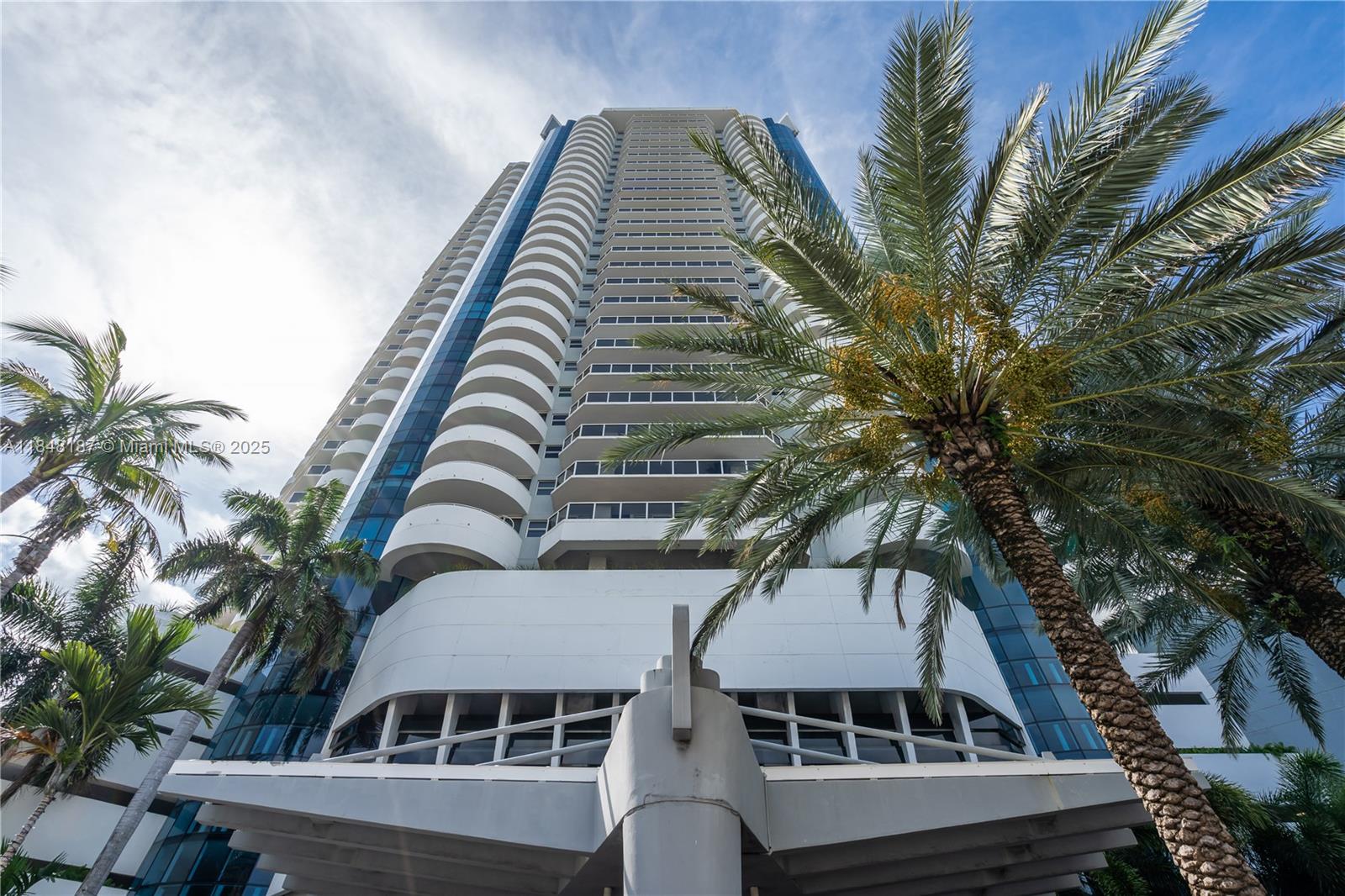 6301 Collins Avenue, Unit 1903 Miami Beach, FL 33141 - Photo 40 of 45 a multi story building with a tree in front of it