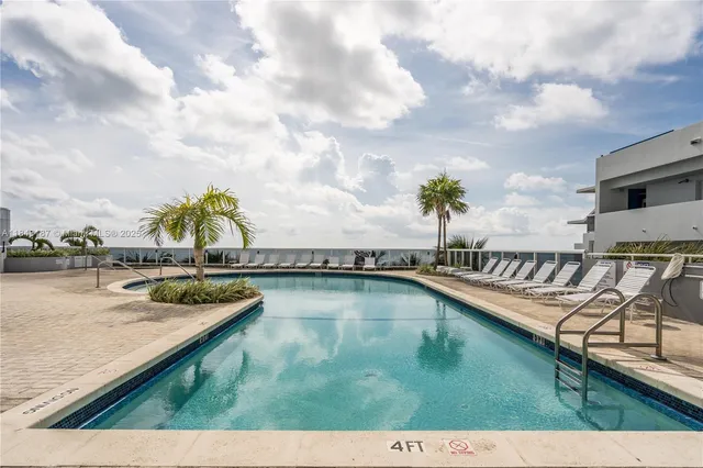 a view of swimming pool with a table and chairs