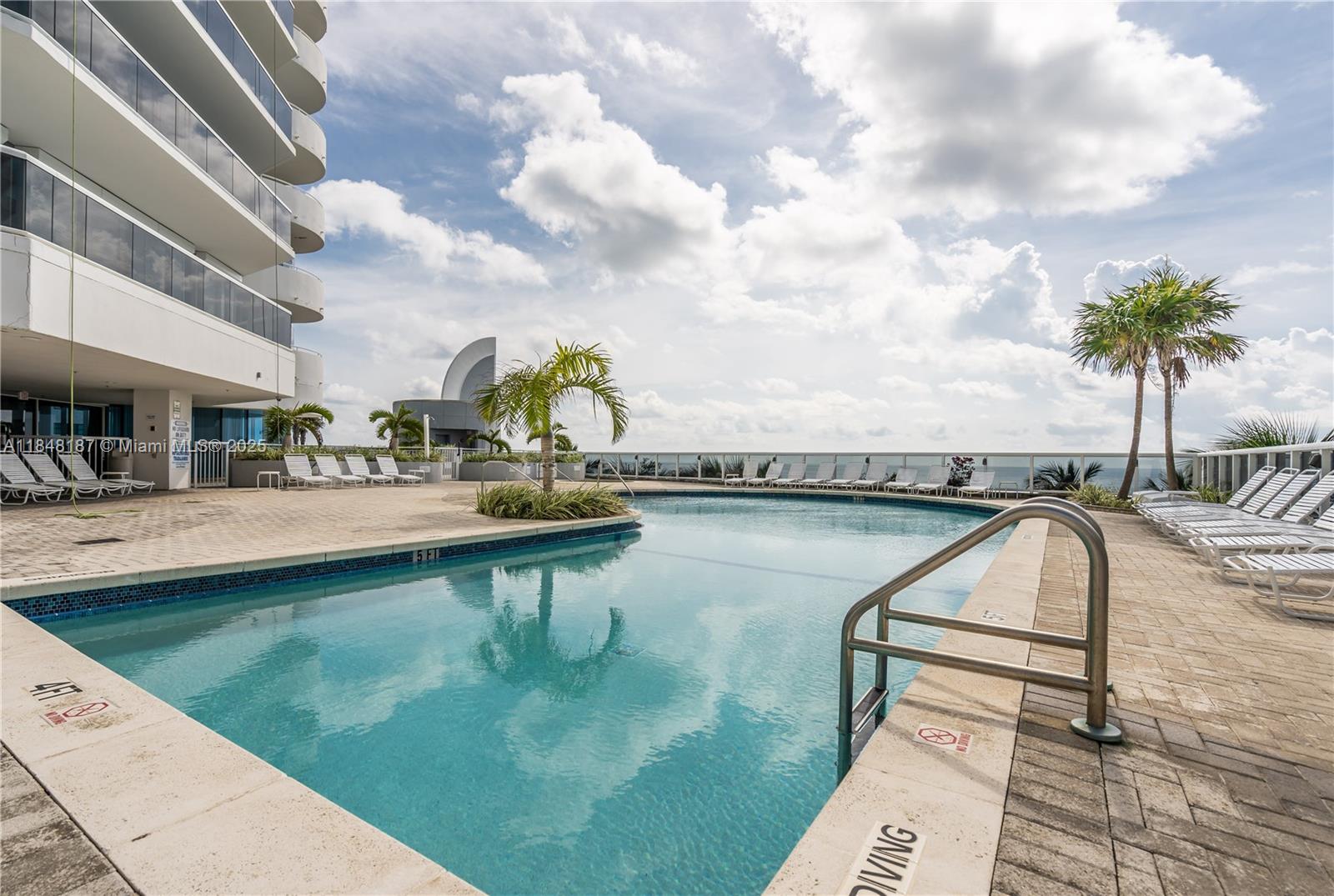 6301 Collins Avenue, Unit 1903 Miami Beach, FL 33141 - Photo 43 of 45 a view of swimming pool with a table and chairs