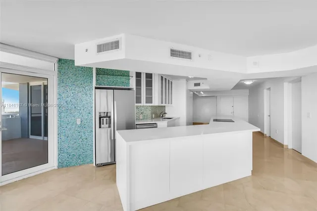 a kitchen with a sink and a stove top oven