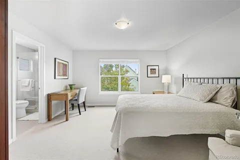 a bedroom with a bed chair and a window