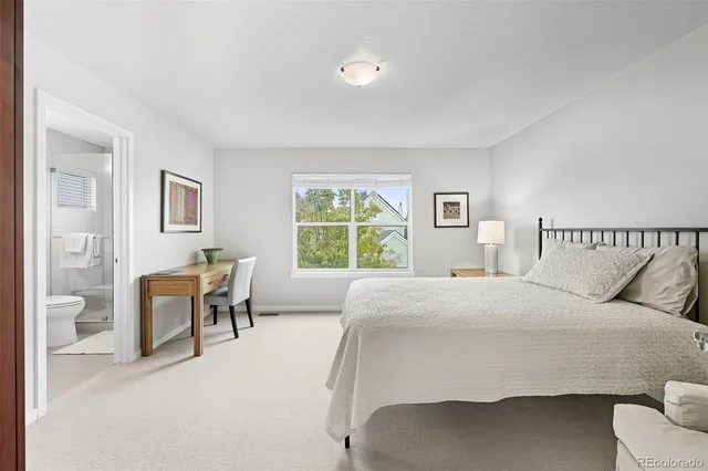 a bedroom with a bed chair and a window