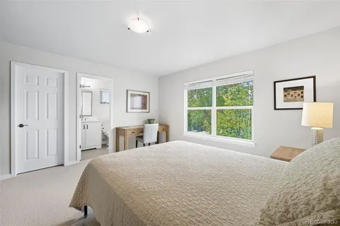 a bedroom with a large bed and a window