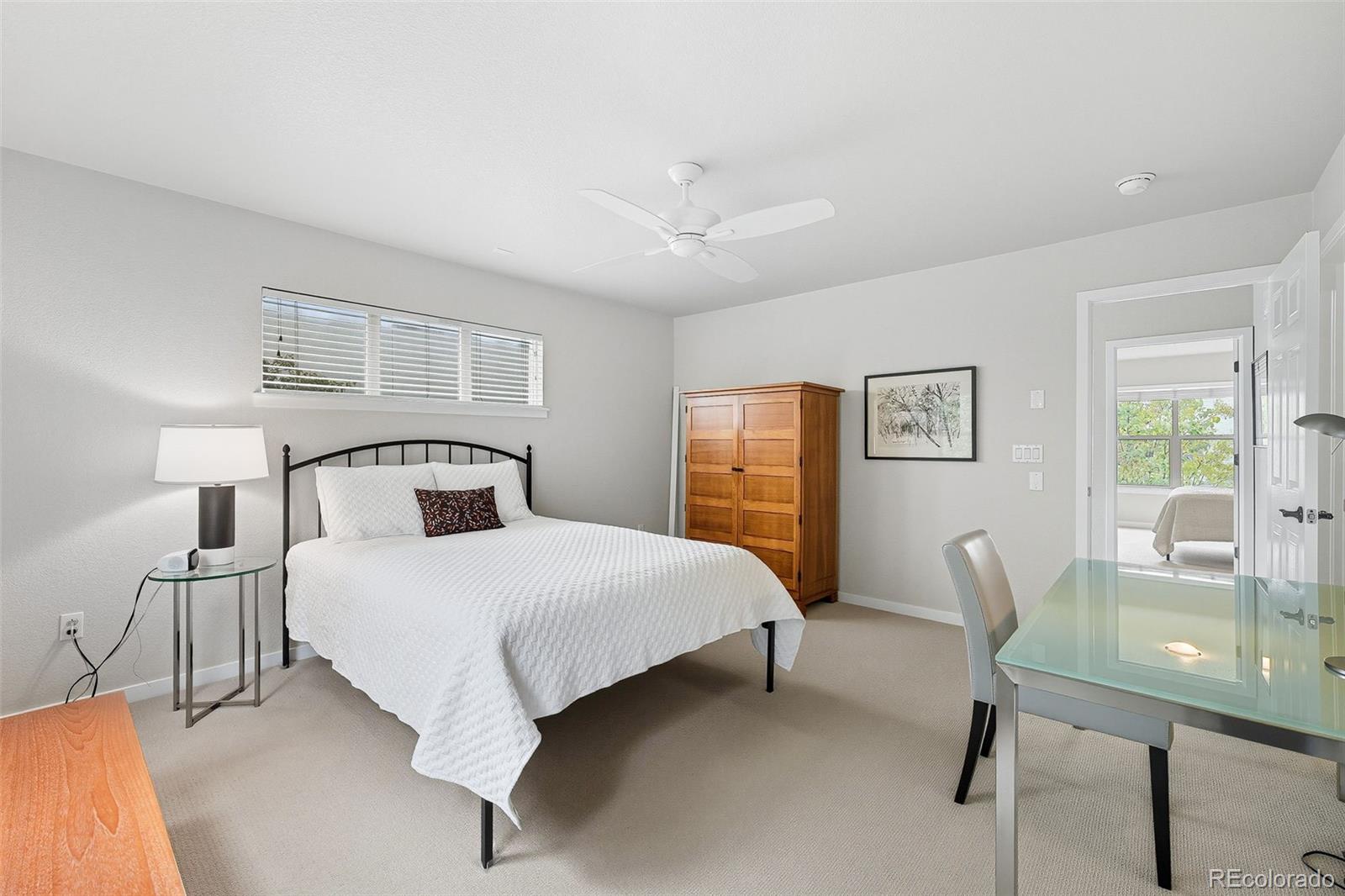 2826 Syracuse Court Denver, CO 80238 - Photo 18 of 35 a bedroom with a bed lamps and window