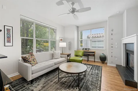a living room with furniture a fireplace and a table