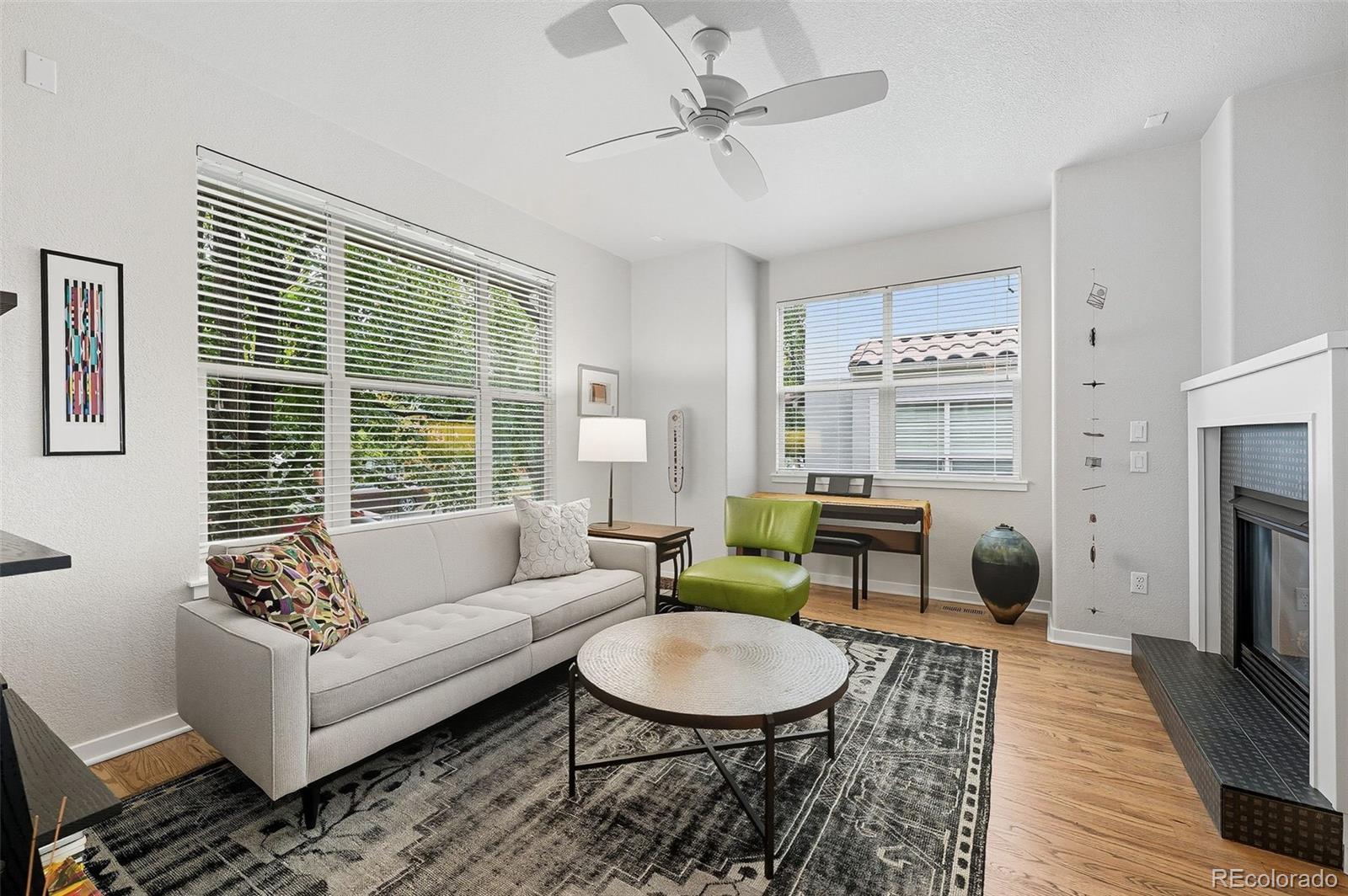 2826 Syracuse Court Denver, CO 80238 - Photo 2 of 35 a living room with furniture a fireplace and a table