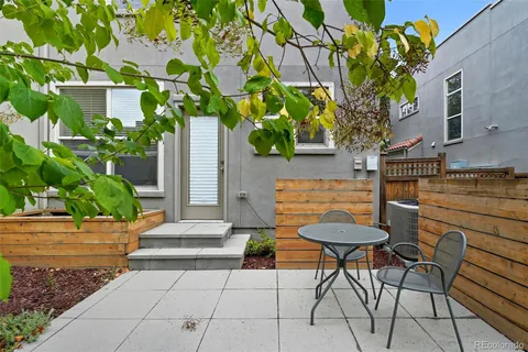 a view of a patio with table and chairs and potted plants