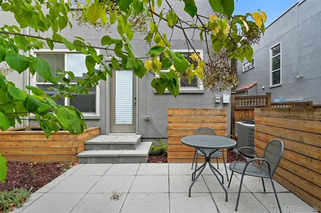 a view of a patio with table and chairs and potted plants