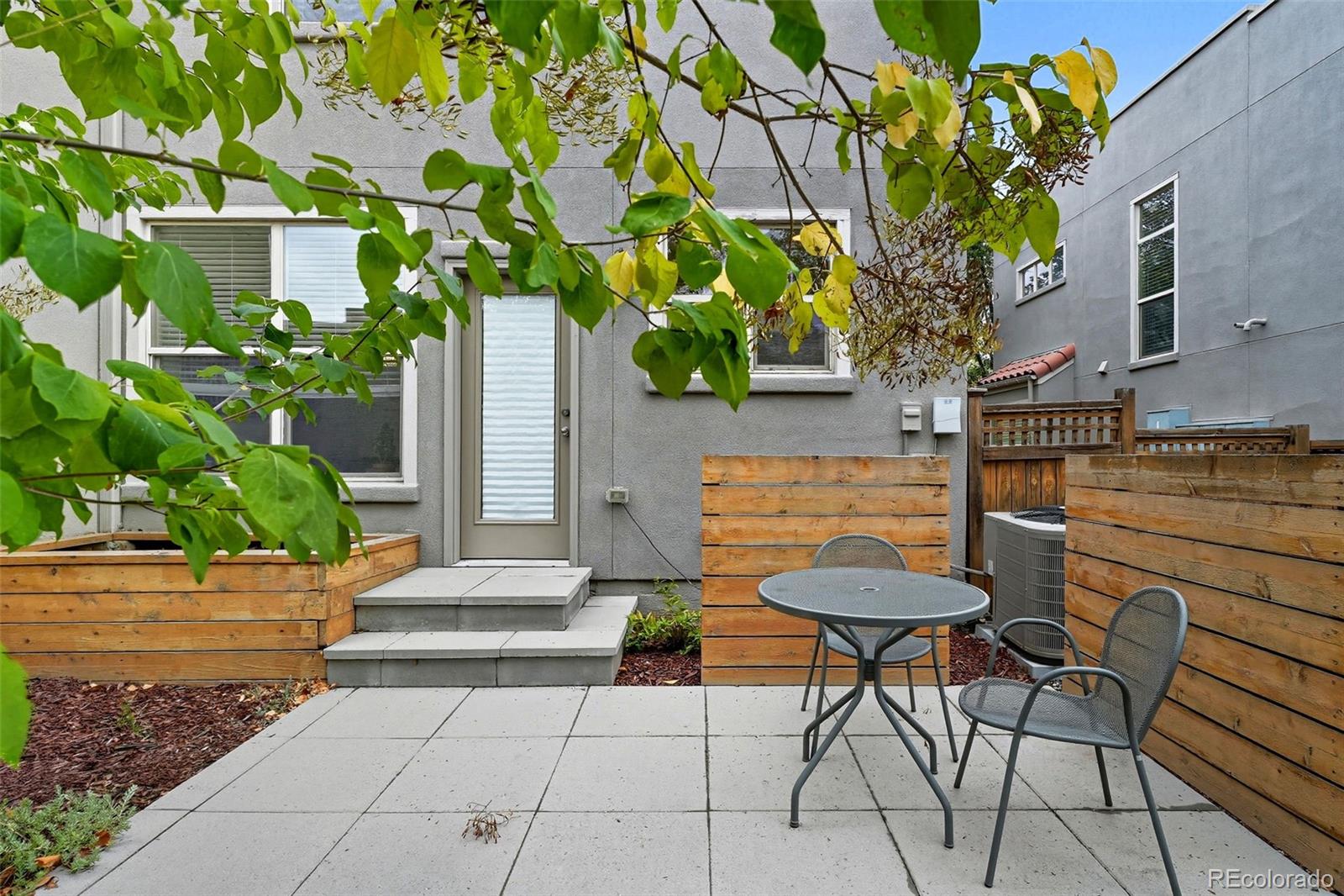 2826 Syracuse Court Denver, CO 80238 - Photo 21 of 35 a view of a patio with table and chairs and potted plants