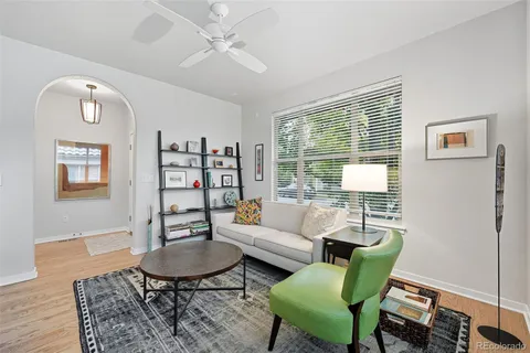 a living room with furniture a rug and a window