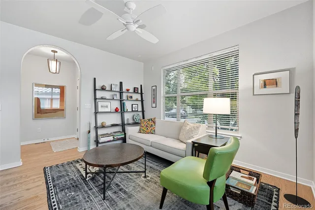a living room with furniture a rug and a window