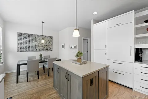 a kitchen with a sink cabinets and wooden floor