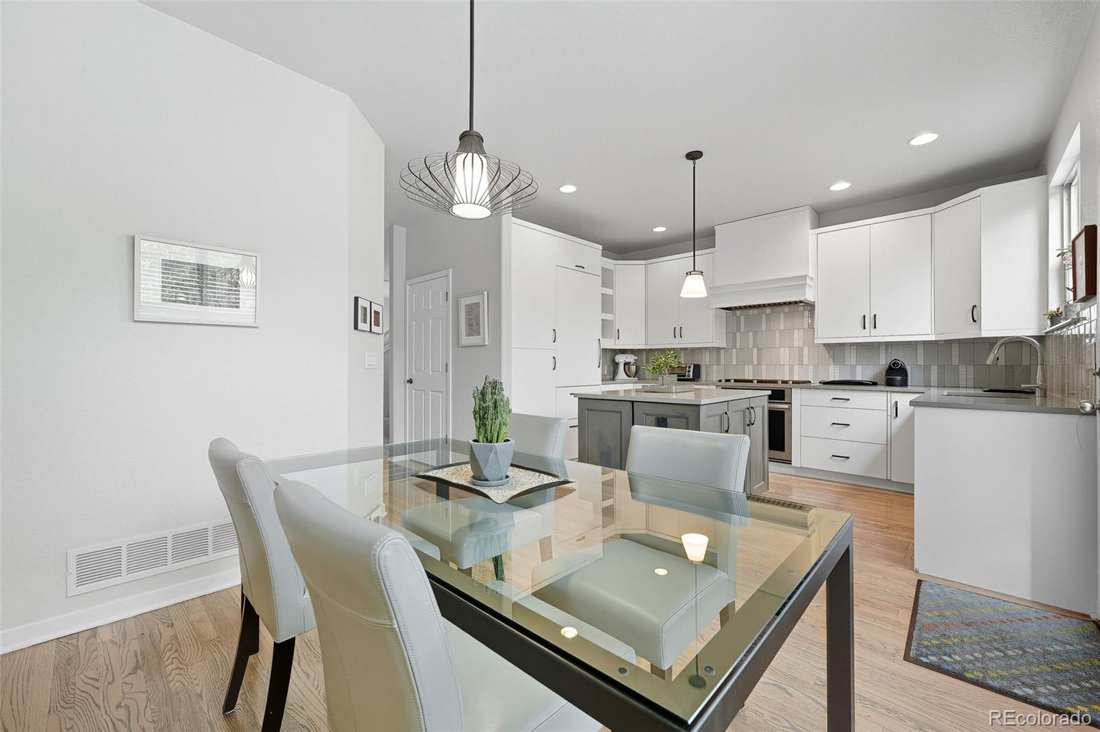 2826 Syracuse Court Denver, CO 80238 - Photo 10 of 35 a living room with stainless steel appliances furniture a dining table and a chandelier