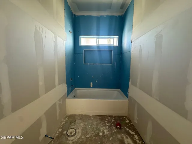 a bathroom with a bathtub and shower