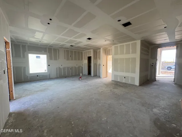 a view of empty room with stairs and a window