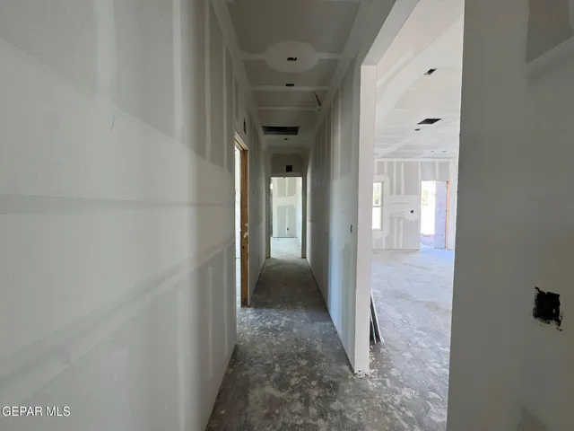 a view of a hallway with wooden shelves