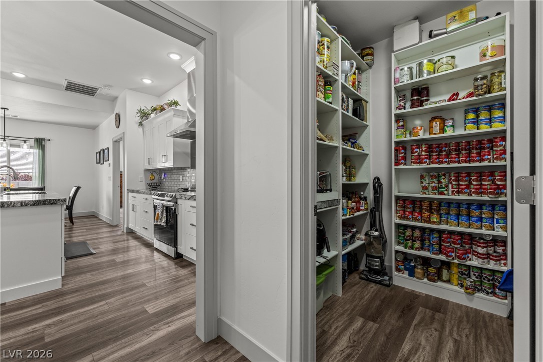 3020 Hannig Street Logandale, NV 89021 - Photo 25 of 75 Ample pantry storage and an inviting kitchen with natural wood flooring await.
