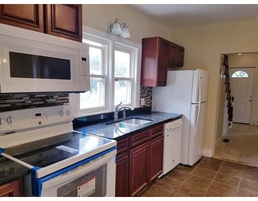 69 Lyons Street Springfield, MA 01151 - Photo 3 of 11 a kitchen with stainless steel appliances kitchen island granite countertop a refrigerator stove and sink