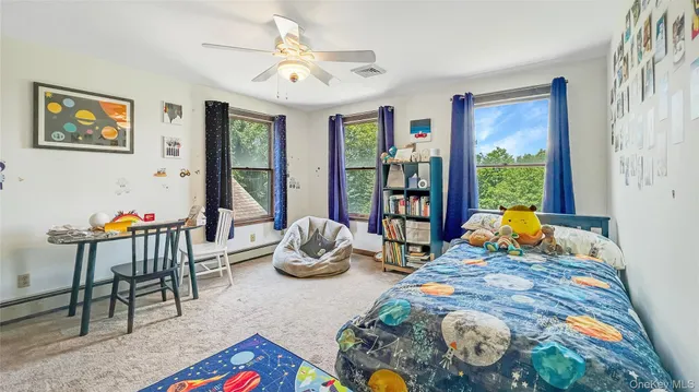 a living room filled with furniture and a floor to ceiling window