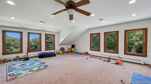 a bedroom with furniture and a large window