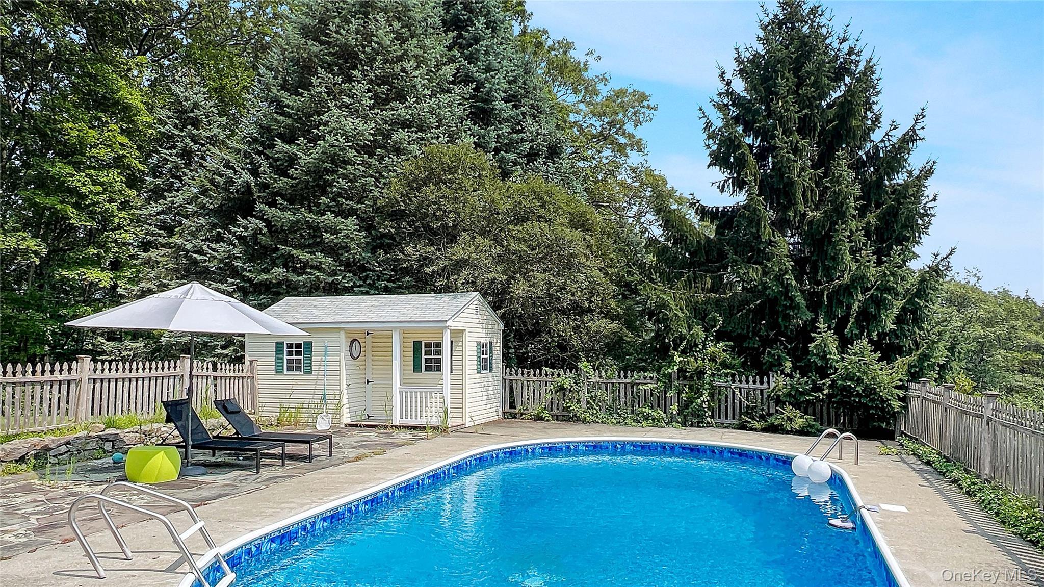 701 Highway 301 Cold Spring, NY 10516 - Photo 17 of 19 a view of a house with swimming pool and sitting area