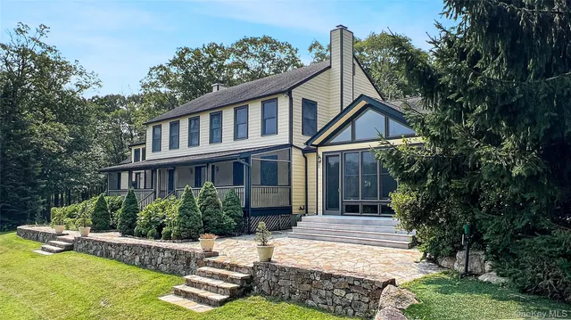 a front view of a house with a yard table and chairs