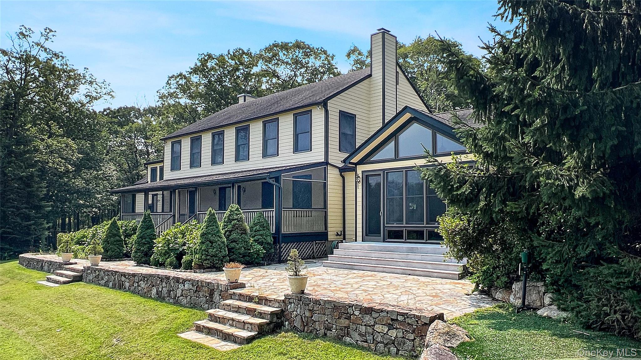 701 Highway 301 Cold Spring, NY 10516 - Photo 2 of 19 a front view of a house with a yard table and chairs