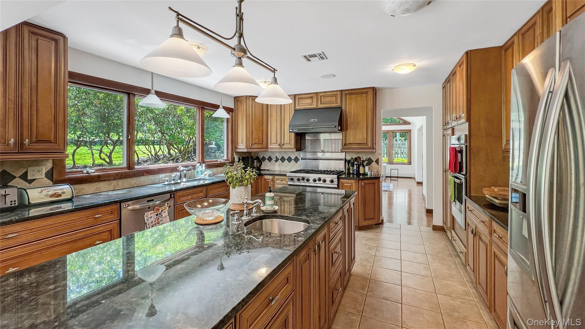 701 Highway 301 Cold Spring, NY 10516 - Photo 3 of 19 a kitchen with stainless steel appliances granite countertop a sink a stove and a refrigerator