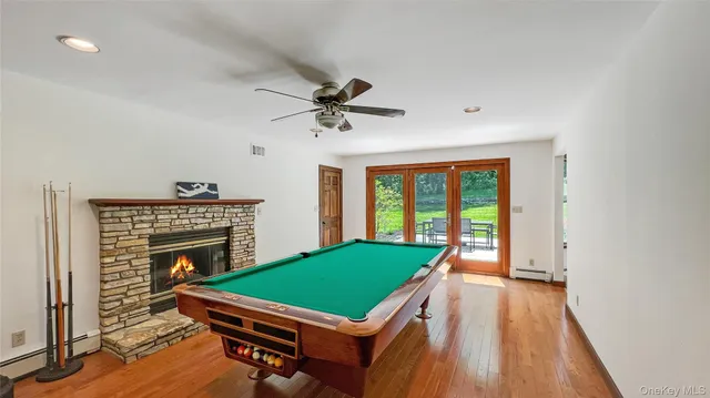 a room with pool table and windows